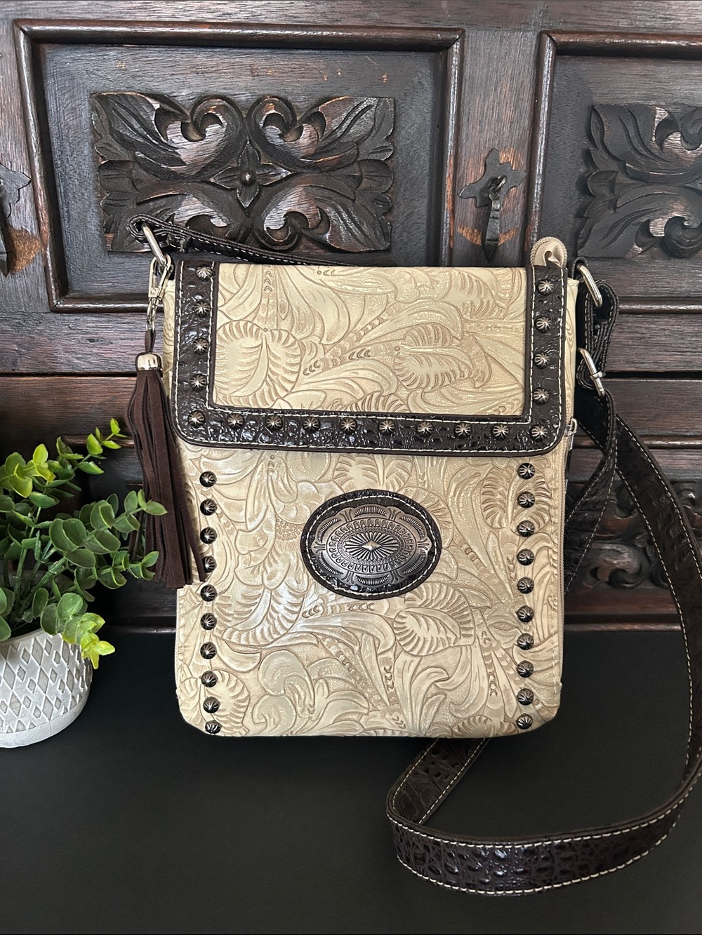 Tooled Cream Crossbody Bag with Dark Brown Trim and Tassel Accent